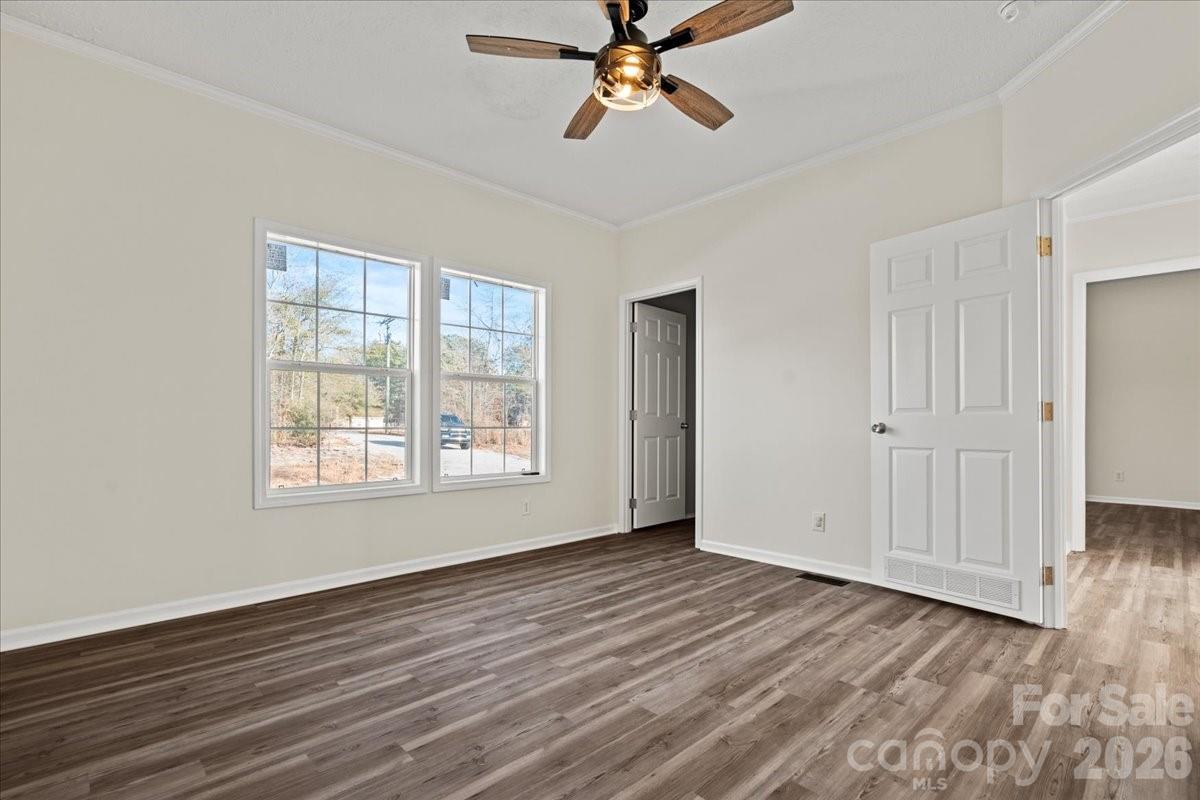 5257 Raleys Mill Road Bethune, SC 29009 - Photo 34 of 48 a view of an empty room with wooden floor and a window