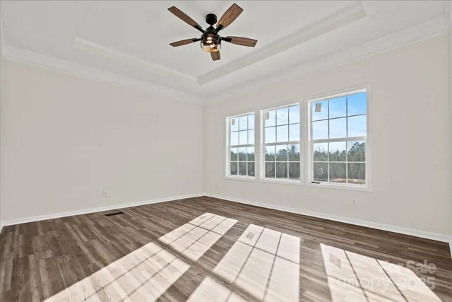 a view of a room with a window and wooden floor