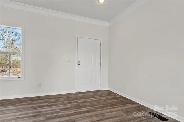 a view of a kitchen with a sink cabinet a ceiling fan and wooden floor