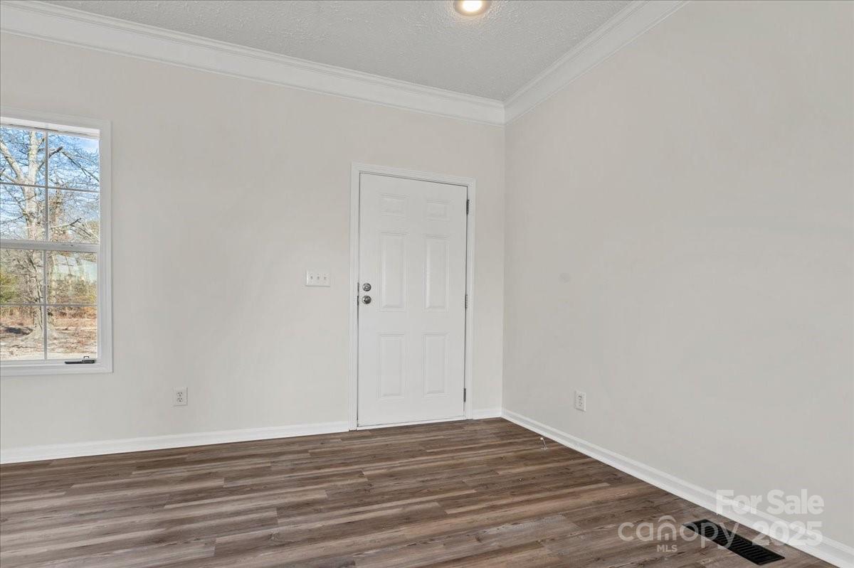 5257 Raleys Mill Road Bethune, SC 29009 - Photo 8 of 48 an empty room with wooden floor and windows