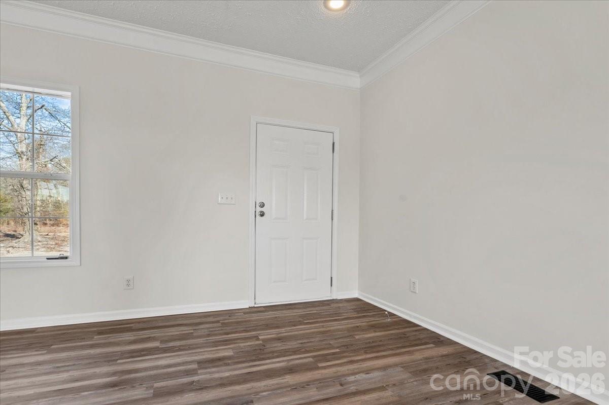 5257 Raleys Mill Road Bethune, SC 29009 - Photo 9 of 48 an empty room with wooden floor and windows