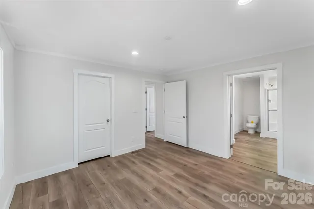 a view of a room with wooden floor