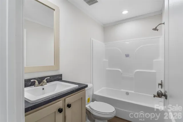 a bathroom with a sink toilet tub and shower