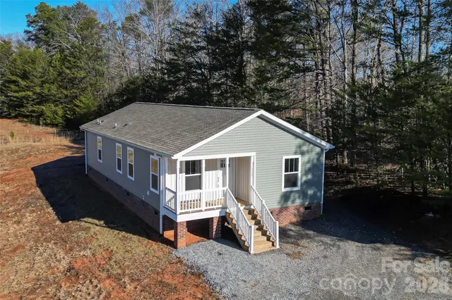 a view of a house with a yard porch and furniture