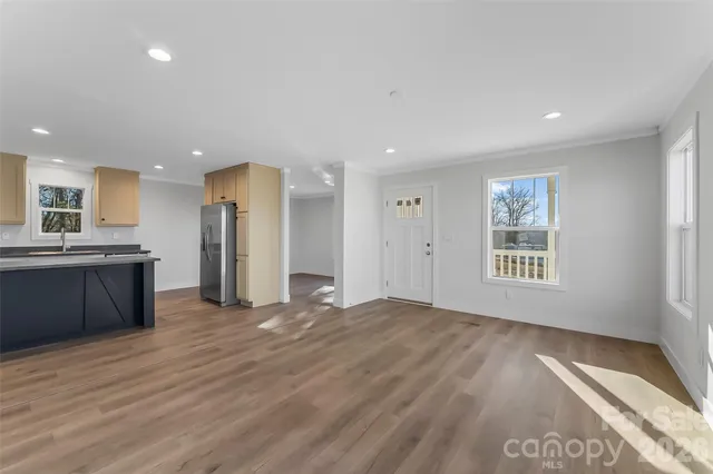 a view of a kitchen with a sink and a refrigerator