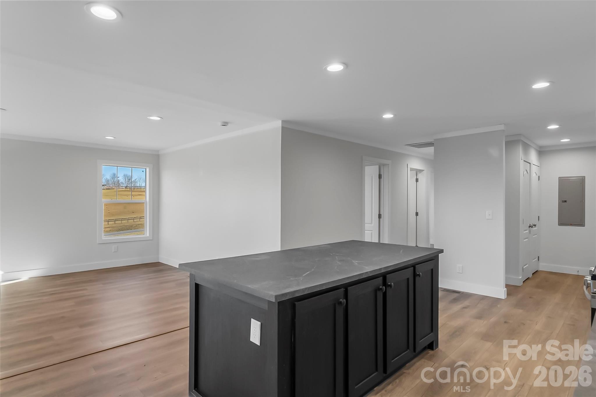1710 Hudlow Road Forest City, NC 28043 - Photo 10 of 23 a kitchen with a stove a sink and a refrigerator with wooden floor