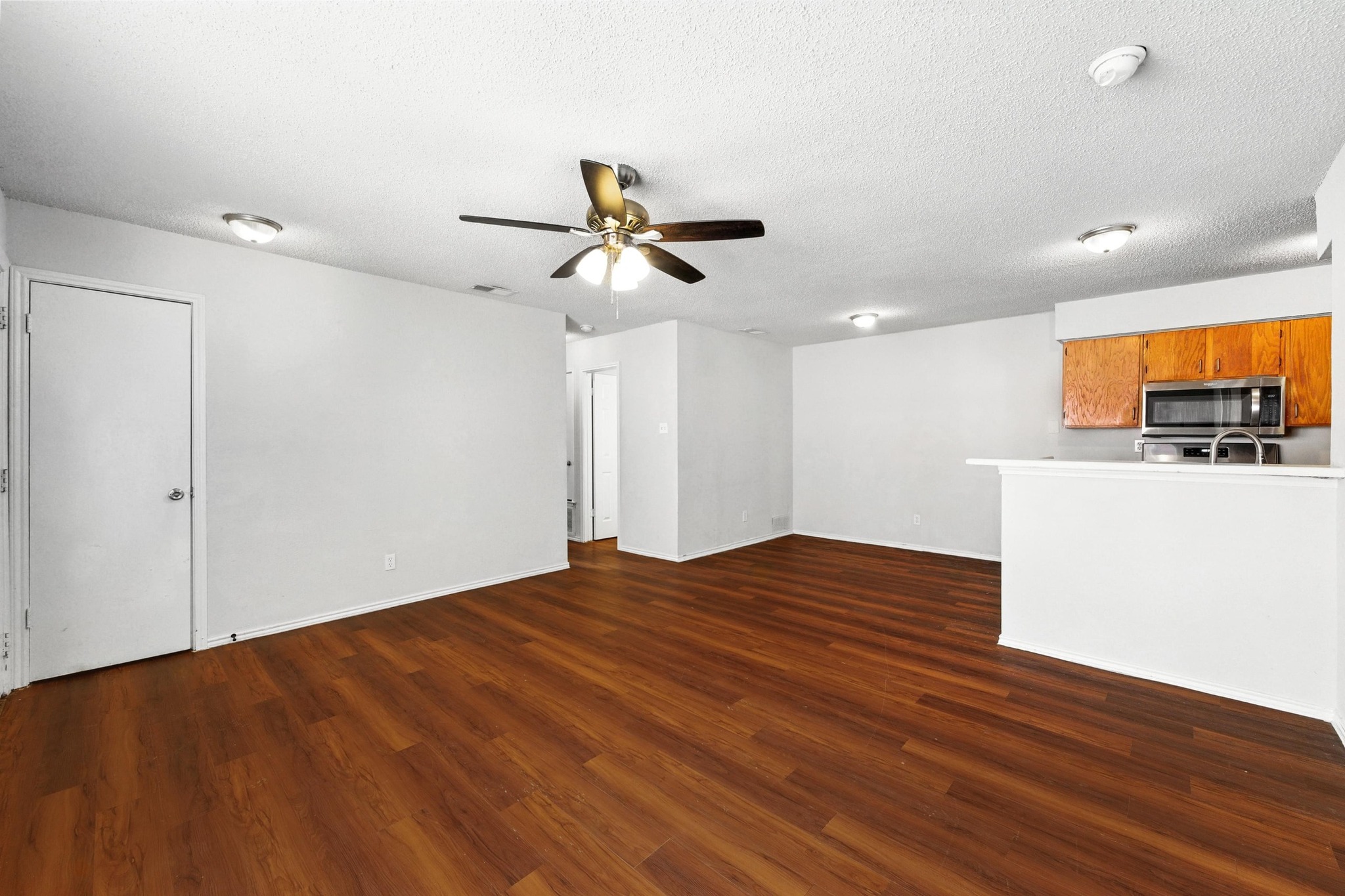 5707 Spring Meadow Road Austin, TX 78744 - Photo 8 of 21 a view of empty room with wooden floor and fan