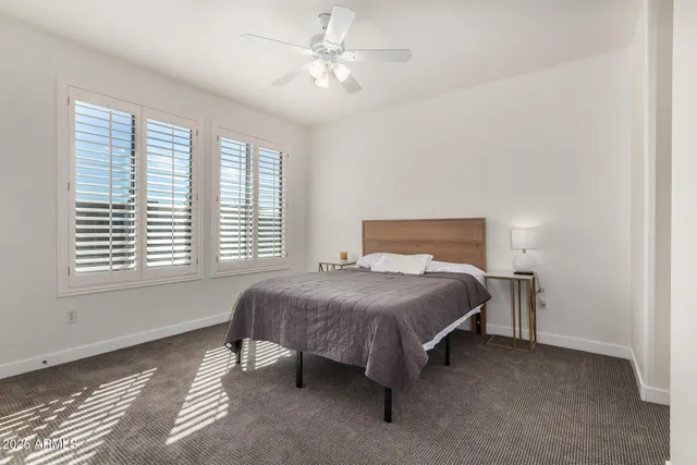 a bedroom with a bed and a table in it