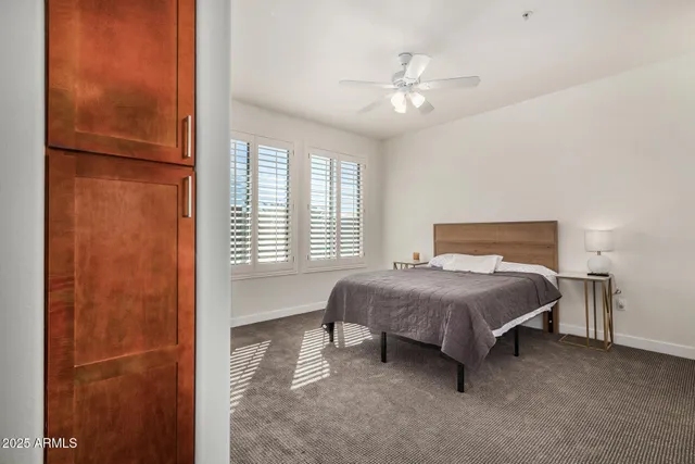 a bedroom with a bed and a chandelier