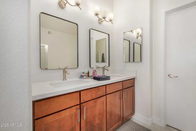 a bathroom with a double vanity sink and a mirror
