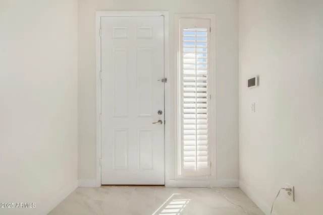 a view of an empty room with windows