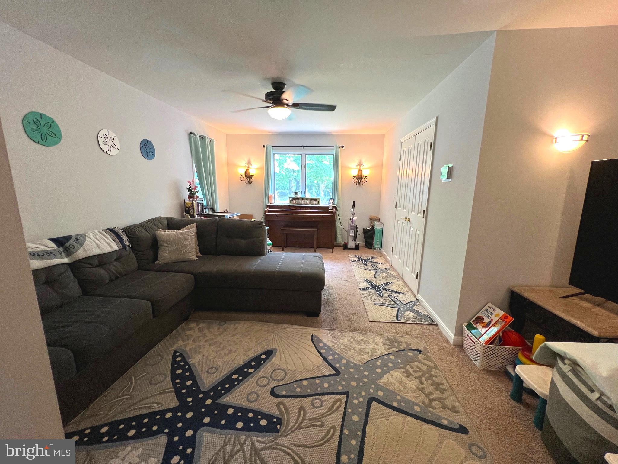 6450 Meadowlark Drive Dunkirk, MD 20754 - Photo 16 of 36 a living room with furniture and a flat screen tv