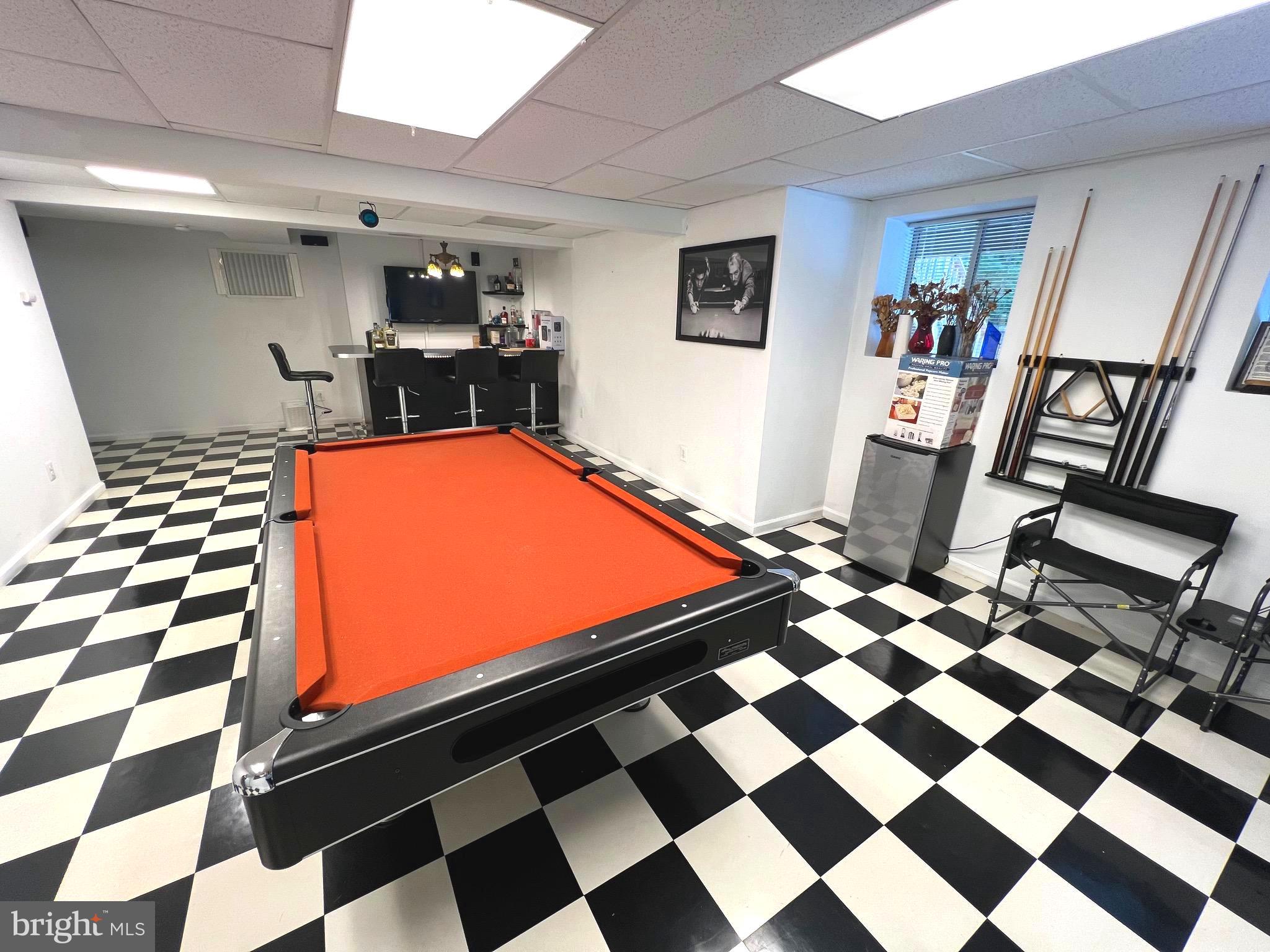 6450 Meadowlark Drive Dunkirk, MD 20754 - Photo 18 of 36 a room with gym equipment and black and white checkered floor