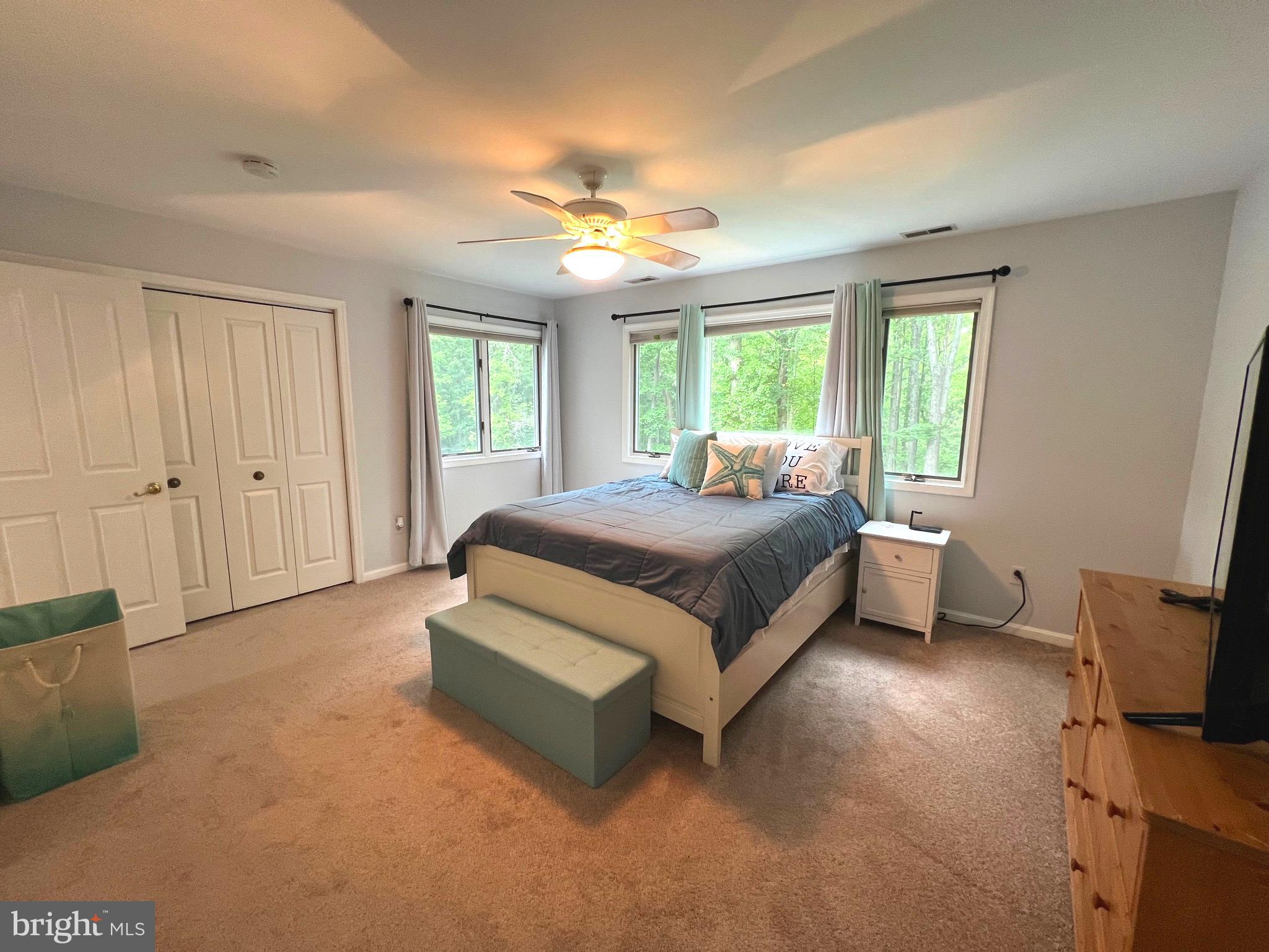 6450 Meadowlark Drive Dunkirk, MD 20754 - Photo 22 of 36 a spacious bedroom with a bed and a chandelier