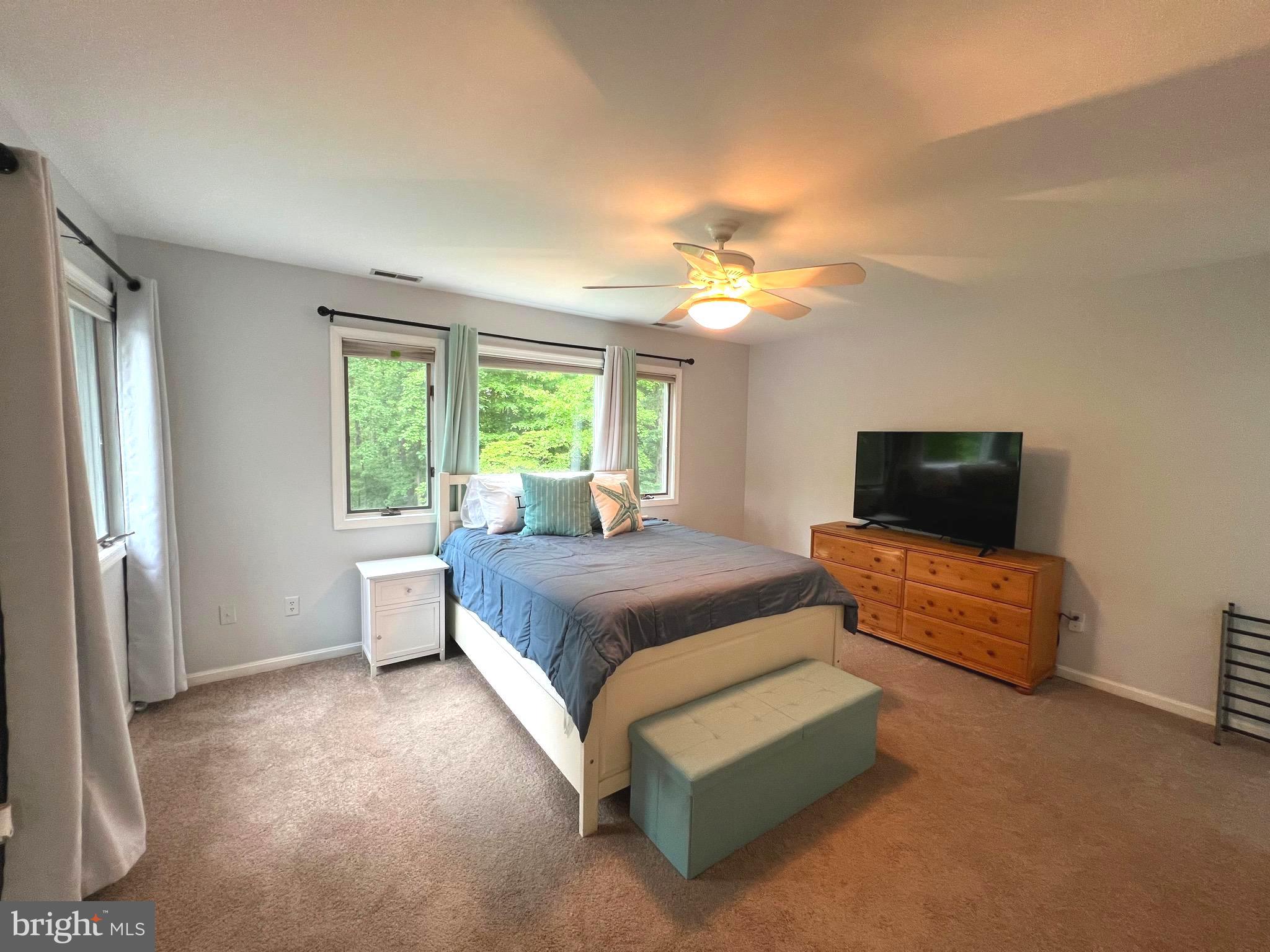 6450 Meadowlark Drive Dunkirk, MD 20754 - Photo 23 of 36 a spacious bedroom with a bed and a couch