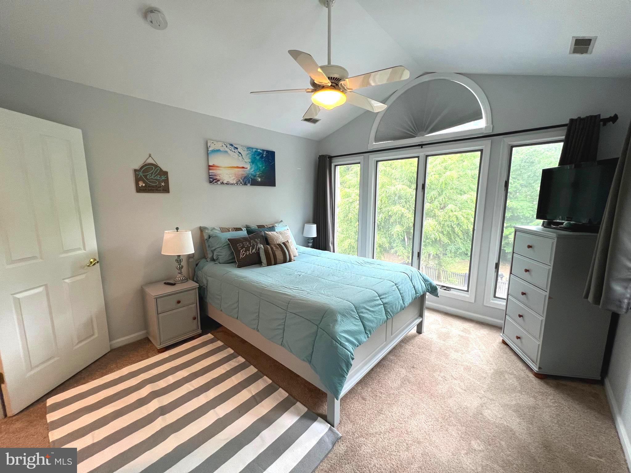 6450 Meadowlark Drive Dunkirk, MD 20754 - Photo 29 of 36 a bedroom with a large bed a flat tv screen and dresser