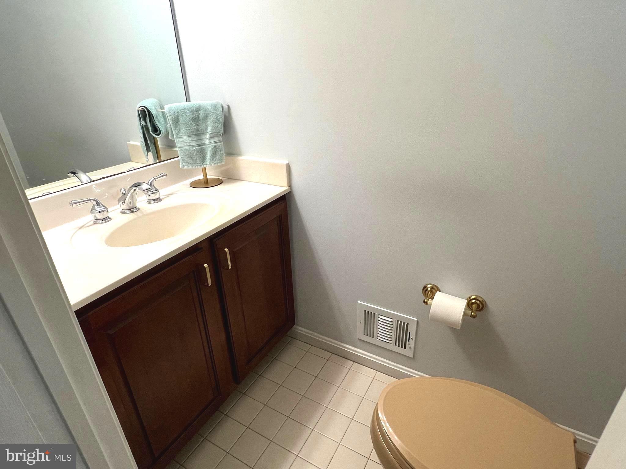 6450 Meadowlark Drive Dunkirk, MD 20754 - Photo 31 of 36 a bathroom with a sink a toilet and mirror