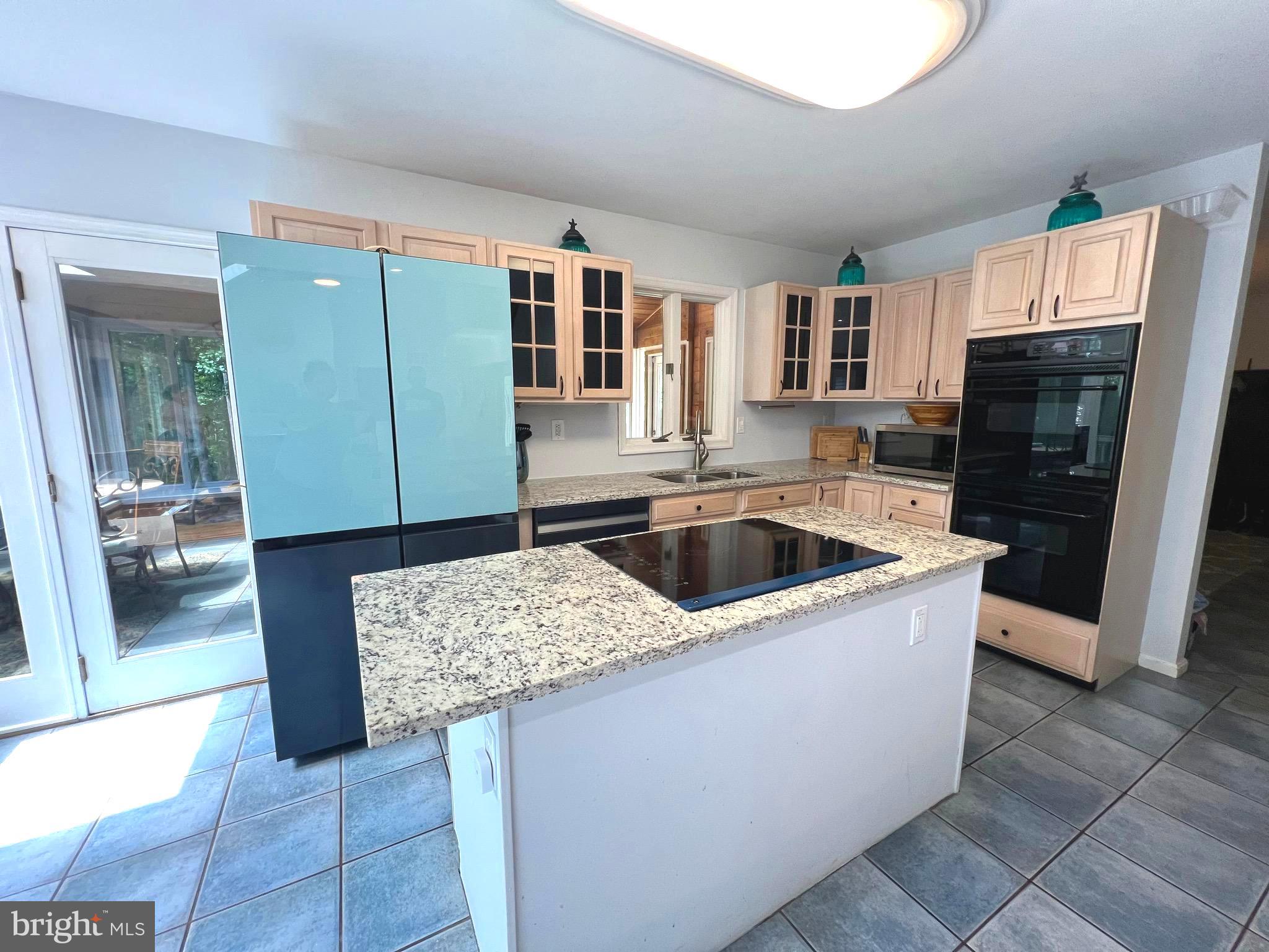 6450 Meadowlark Drive Dunkirk, MD 20754 - Photo 7 of 36 a kitchen with stainless steel appliances granite countertop a sink and a refrigerator