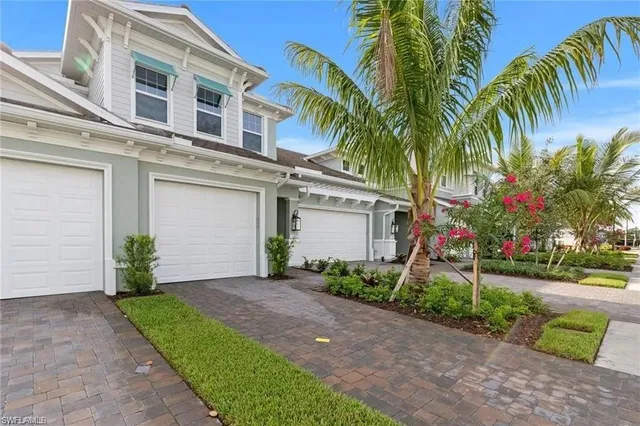 a front view of a house with a yard and a garage
