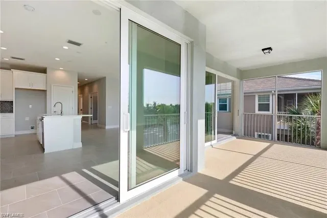 a view of street with an umbrella and palm trees