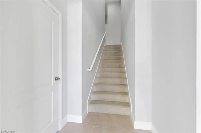 a view of staircase with white walls