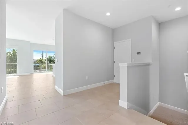 an empty room with windows and entrance