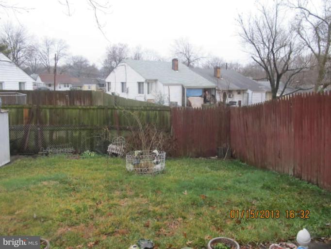 7617 Oxman Road Hyattsville, MD 20785 - Photo 6 of 9 a view of a backyard with table and chairs and wooden fence