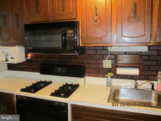 7617 Oxman Road Hyattsville, MD 20785 - Photo 8 of 9 a kitchen with sink and cabinets