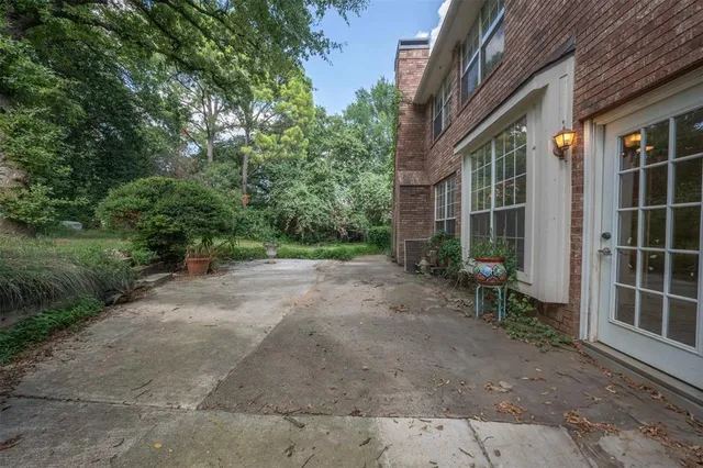 a view of a house with a yard and pathway