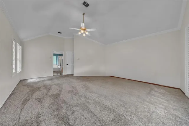 a view of empty room with ceiling fan