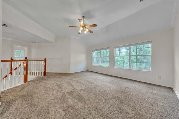 a view of a livingroom with a ceiling fan and window