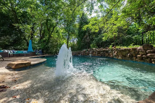 a view of a backyard with swimming pool