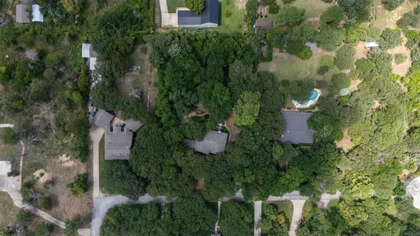 an aerial view of a house with swimming pool and garden