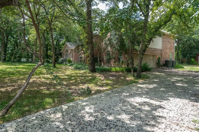 a view of a tree in front of a house