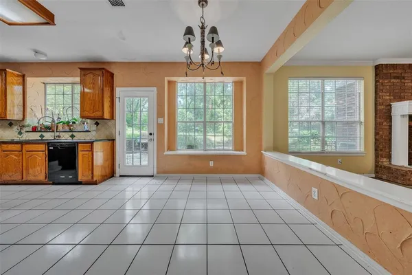 a large kitchen with kitchen island granite countertop a stove a sink and a bathtub