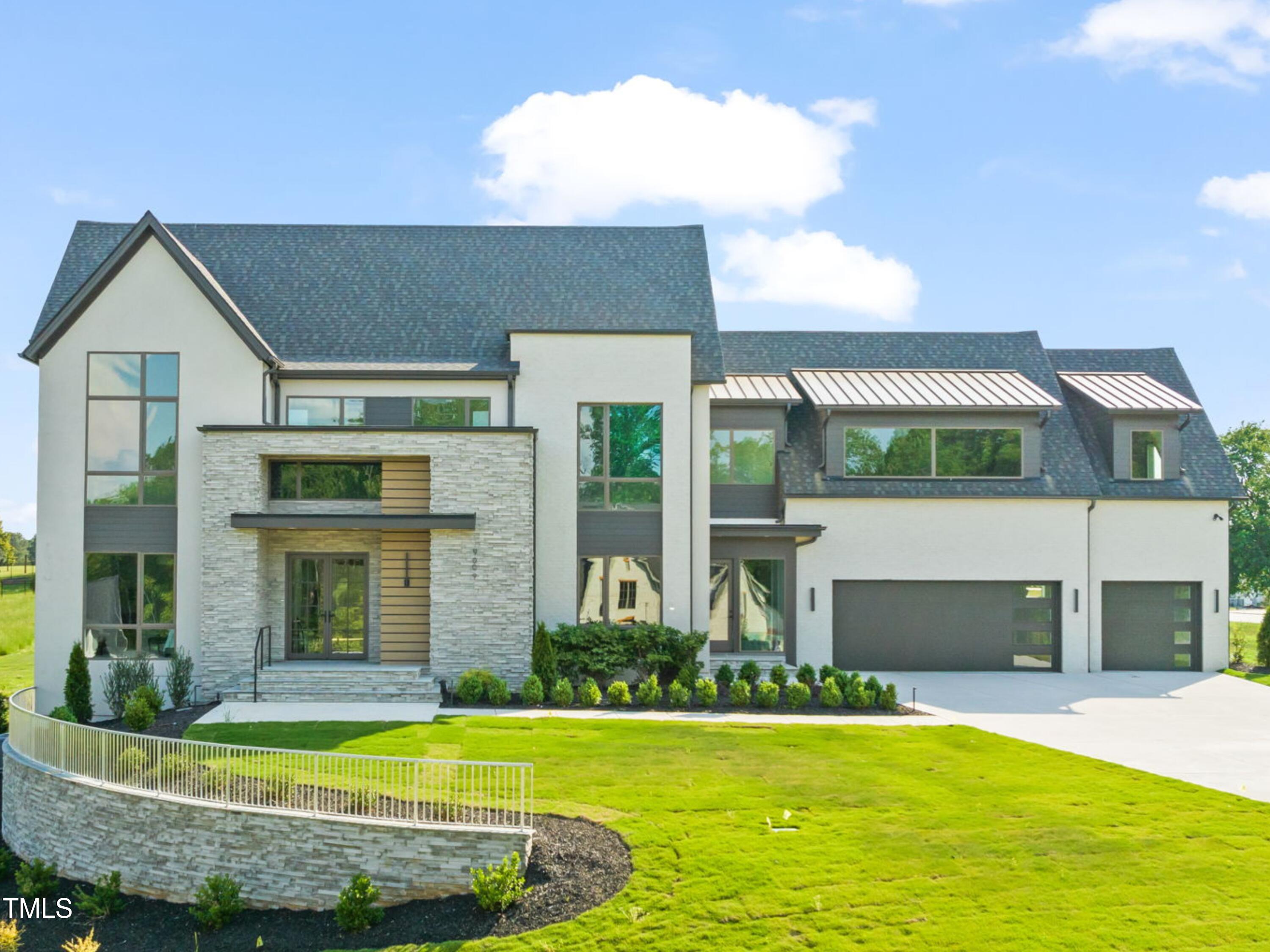 9009 Meadow Pointe Court Wake Forest, NC 27587 - Photo 2 of 76 a front view of a house with a yard and garage
