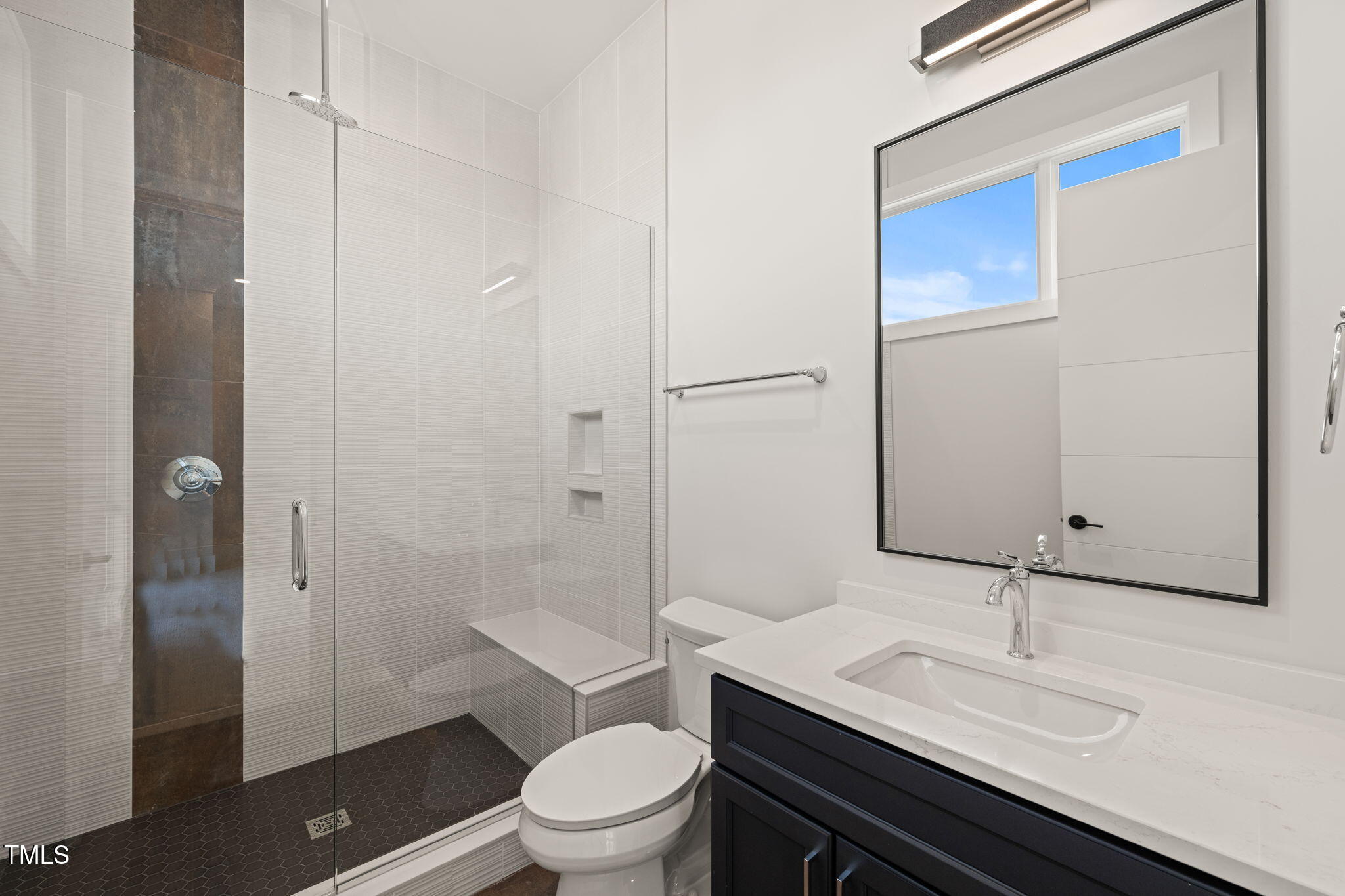 9009 Meadow Pointe Court Wake Forest, NC 27587 - Photo 58 of 76 a bathroom with a sink a toilet and shower