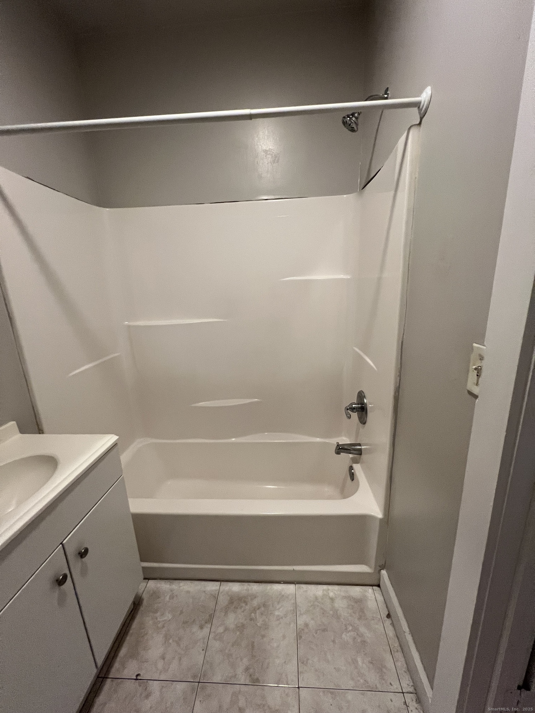 385 Putnam Avenue, Unit 26 Hamden, CT 06517 - Photo 11 of 11 a bathroom with a bathtub and a shower