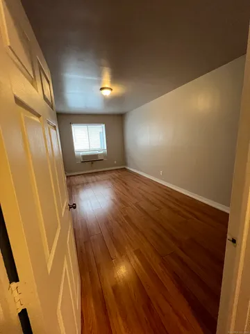 a view of an empty room and wooden floor