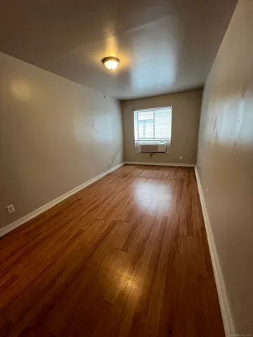 a view of an empty room and wooden floor