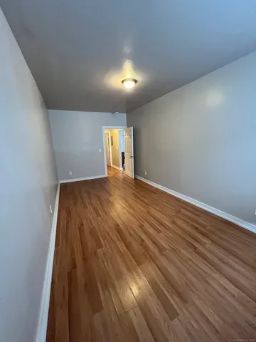 a view of a room with wooden floor and staircase
