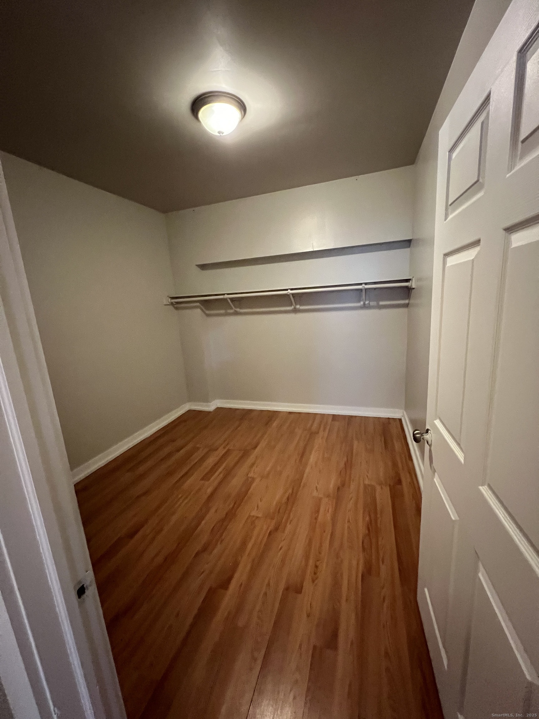 385 Putnam Avenue, Unit 26 Hamden, CT 06517 - Photo 9 of 11 a view of a room with wooden floor and staircase