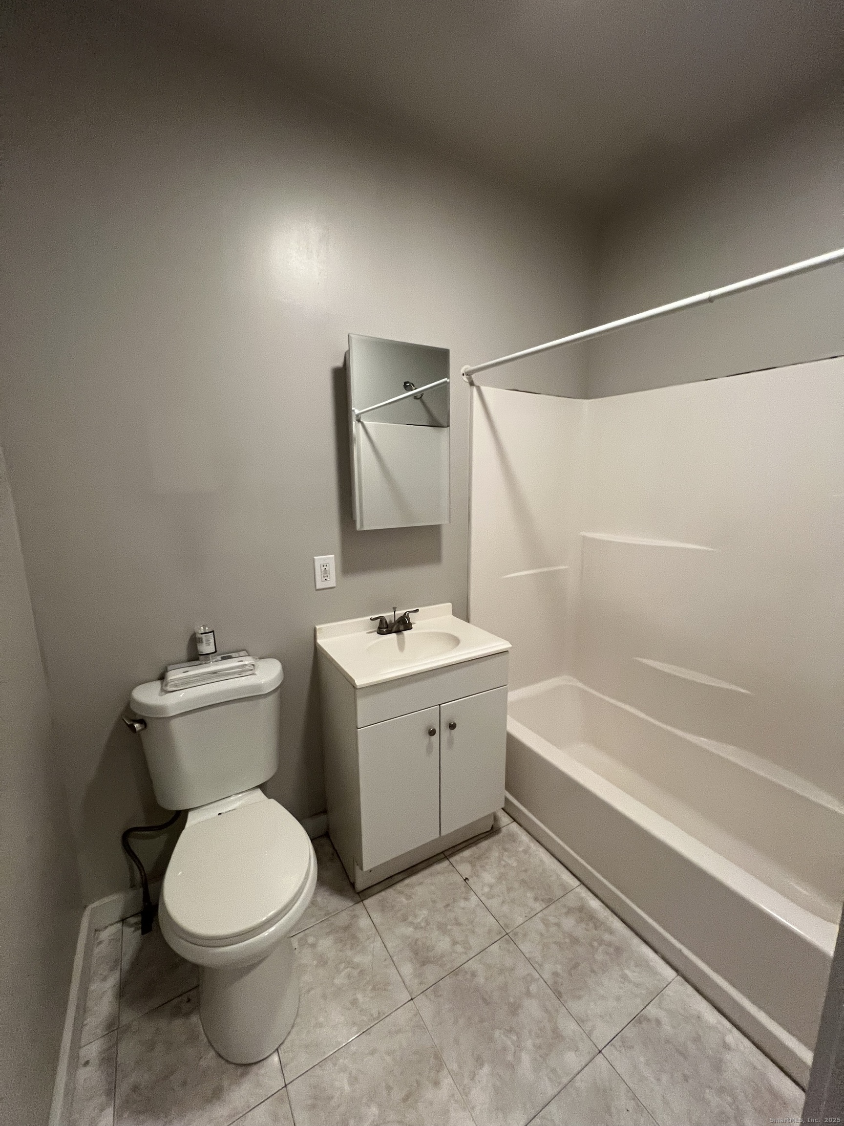 385 Putnam Avenue, Unit 26 Hamden, CT 06517 - Photo 10 of 11 a bathroom with a sink a toilet and bathtub