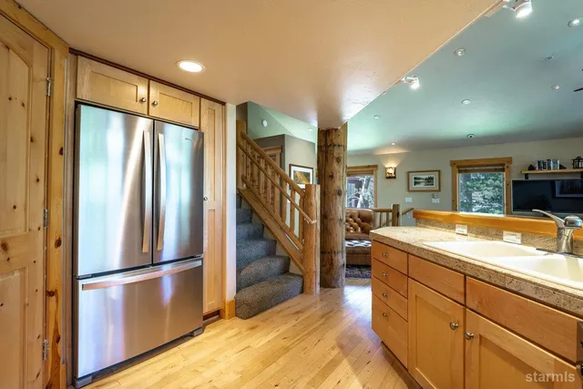 a kitchen with stainless steel appliances granite countertop a refrigerator and a sink