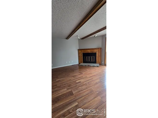 a view of an empty room with a fireplace