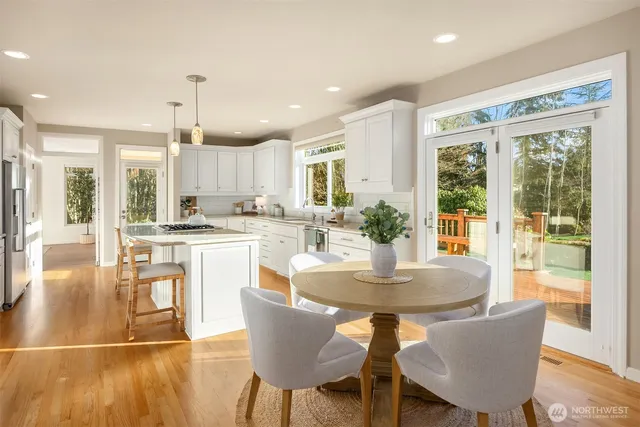 a view of a dining room with furniture wooden floor and a chandelier