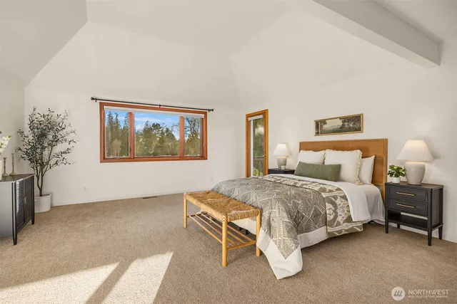 a spacious bedroom with a bed and a couch