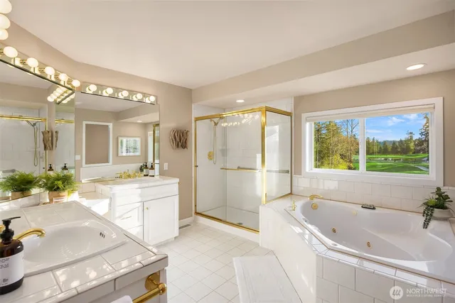 a spacious bathroom with a tub sink shower and mirror