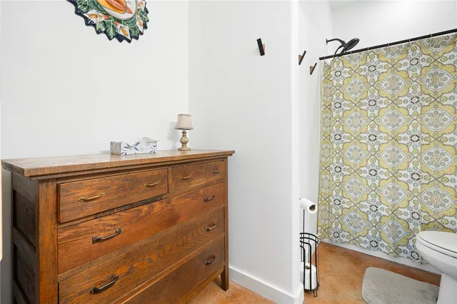 a bedroom with a bed and a dresser