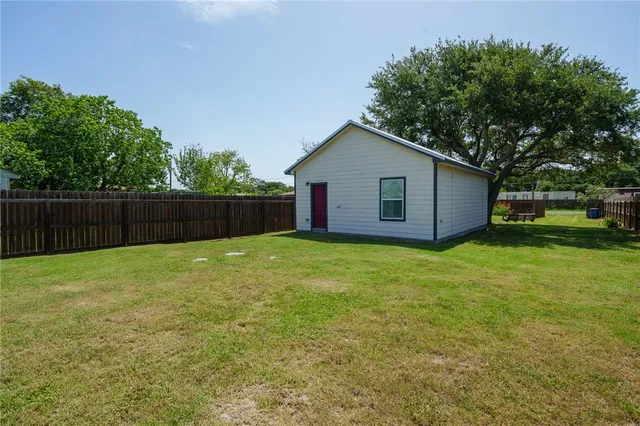 a view of a backyard with wooden fence